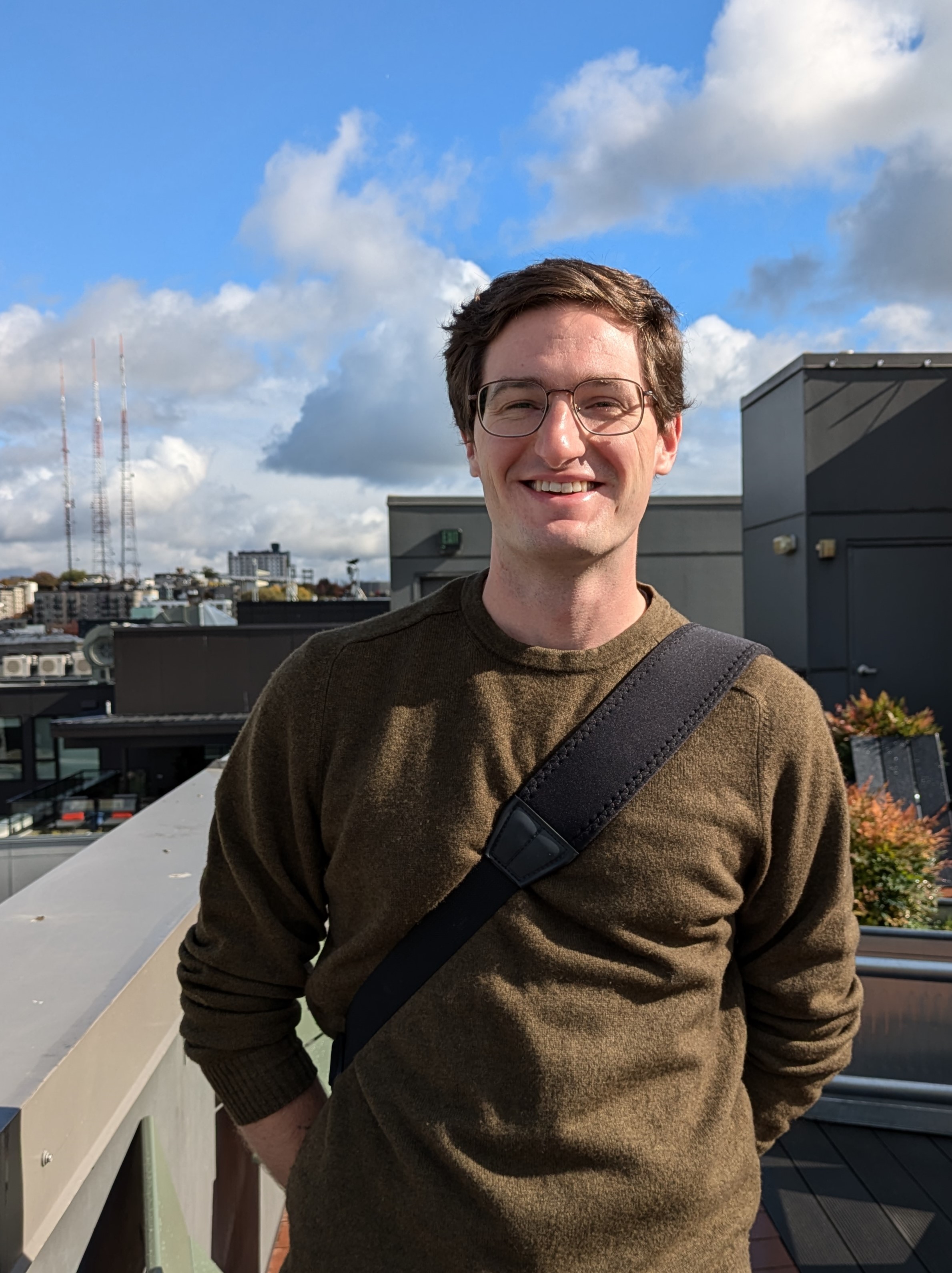 A photo of Will Sutherland standing on a rooftop on a sunny day.